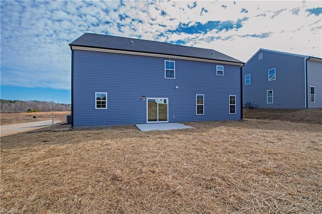 rear view of property with a patio and a yard