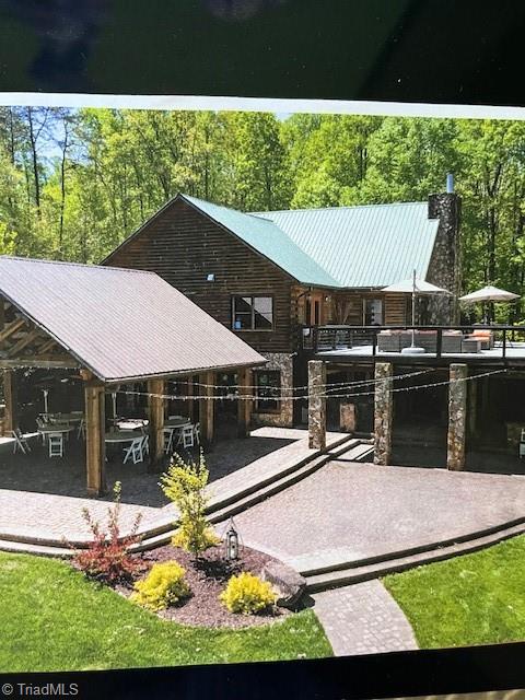 rear view of property featuring a gazebo