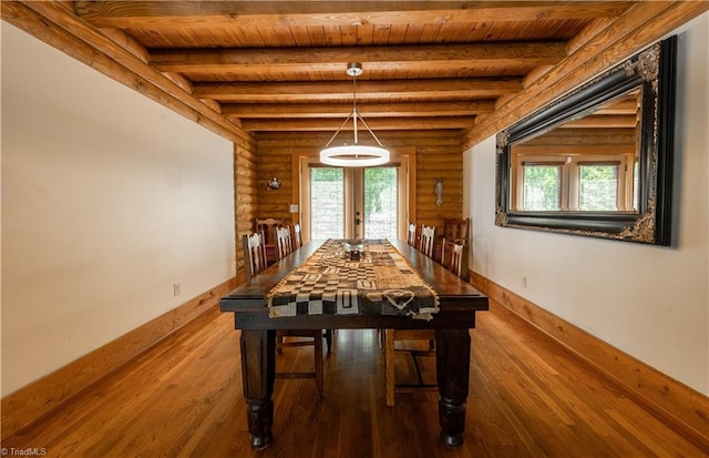 unfurnished dining area with wood ceiling, hardwood / wood-style floors, beamed ceiling, and french doors