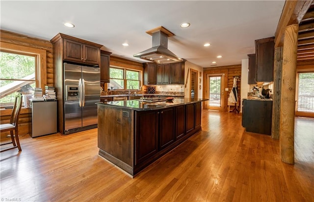 kitchen with island exhaust hood, light hardwood / wood-style floors, stainless steel appliances, and plenty of natural light