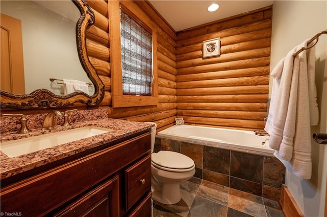 bathroom featuring vanity, toilet, rustic walls, and a relaxing tiled tub