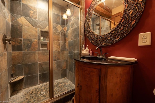 bathroom with vanity and a shower with door