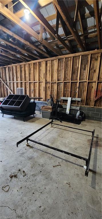 misc room with unfinished concrete flooring