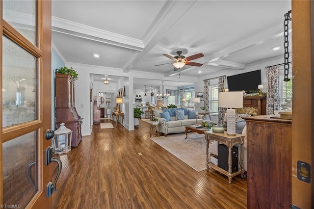 living area featuring beam ceiling, a ceiling fan, dark wood-type flooring, ornamental molding, and coffered ceiling