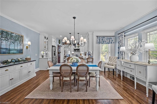 dining room with baseboards, ornamental molding, dark wood finished floors, and a notable chandelier