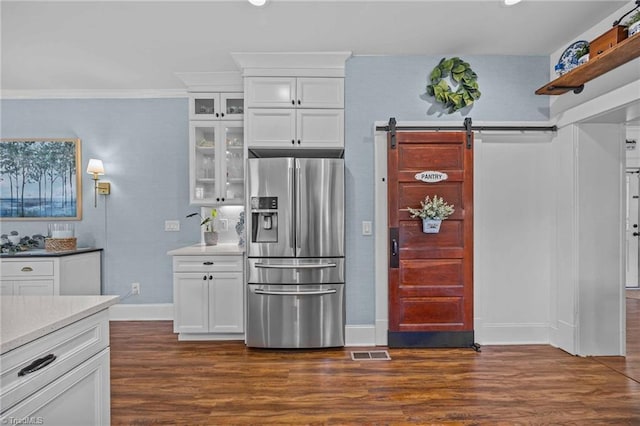 kitchen featuring stainless steel fridge with ice dispenser, dark wood finished floors, white cabinetry, baseboards, and glass insert cabinets
