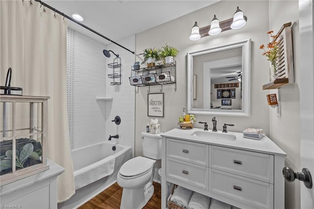 full bath featuring toilet, wood finished floors, shower / tub combo with curtain, and vanity