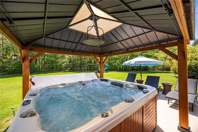 exterior space with a lawn, a gazebo, and a hot tub