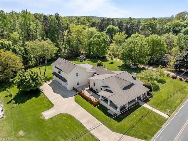 birds eye view of property with a view of trees
