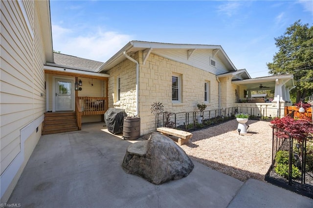 view of side of property featuring stone siding