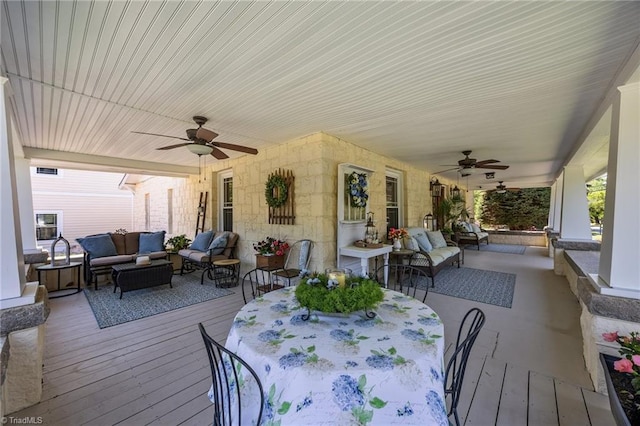 wooden terrace featuring an outdoor hangout area and a ceiling fan