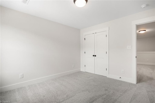 unfurnished bedroom featuring a closet and carpet