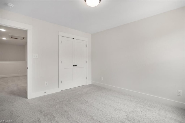 unfurnished bedroom with carpet flooring and a closet