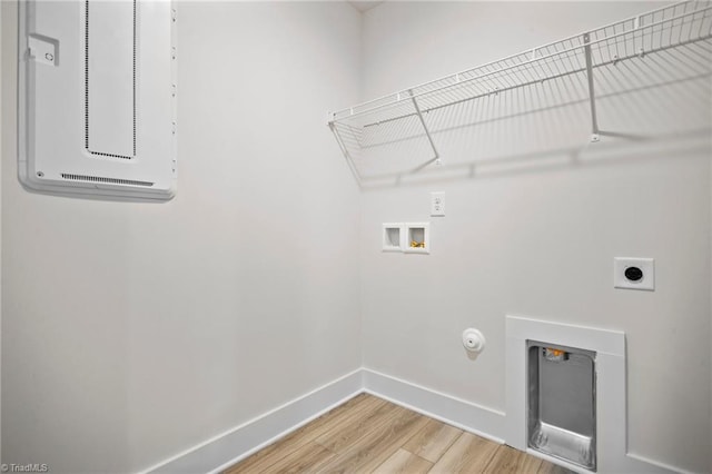 washroom featuring hookup for a washing machine, hookup for an electric dryer, light wood-type flooring, and gas dryer hookup