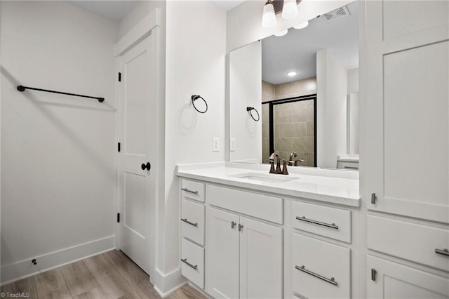 bathroom with vanity and hardwood / wood-style flooring