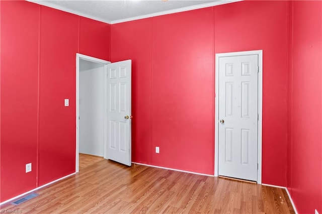 103 Forest Dr, King, NC 27021 - unfurnished bedroom with light wood finished floors and ornamental molding