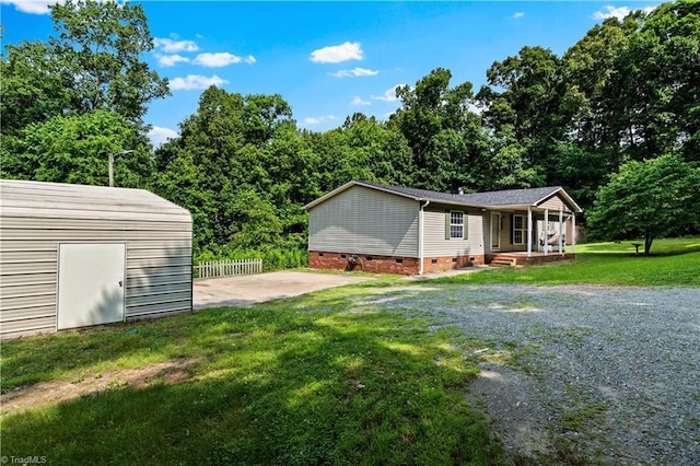 103 Forest Dr, King, NC 27021 - view of side of property featuring crawl space, covered porch, and an outbuilding