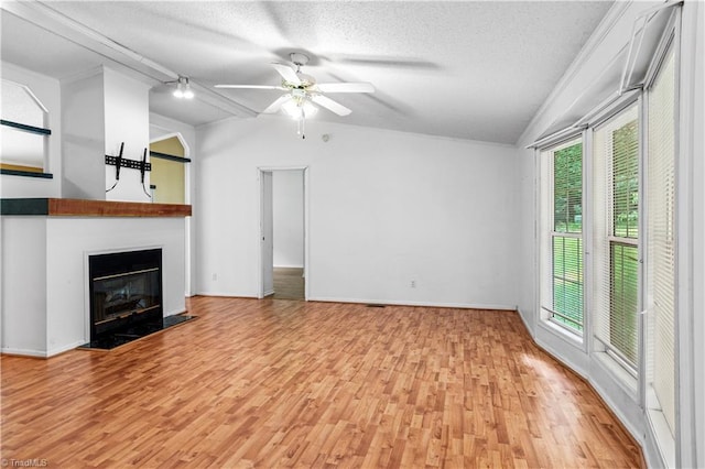 103 Forest Dr, King, NC 27021 - unfurnished living room with light wood-type flooring, a fireplace with flush hearth, lofted ceiling, a textured ceiling, and ceiling fan