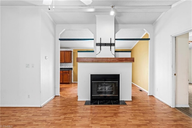 103 Forest Dr, King, NC 27021 - unfurnished living room featuring light wood-type flooring, ornamental molding, and a fireplace with flush hearth