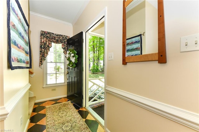 doorway featuring crown molding and tile patterned floors