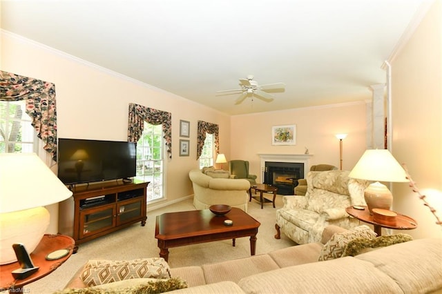 living room featuring carpet floors, crown molding, a fireplace, and ceiling fan