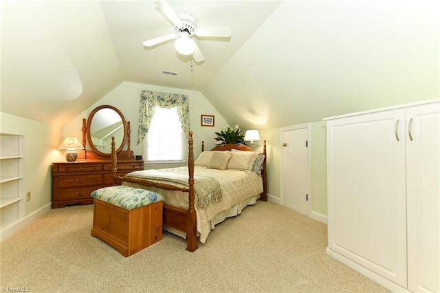 bedroom with ceiling fan, light carpet, vaulted ceiling, and visible vents