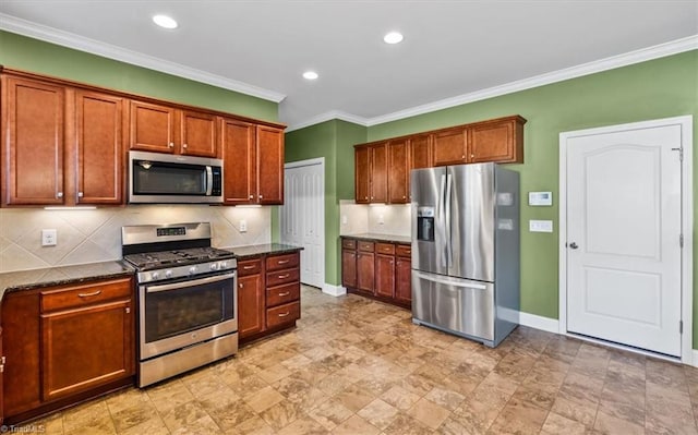 kitchen with dark stone countertops, appliances with stainless steel finishes, backsplash, and ornamental molding