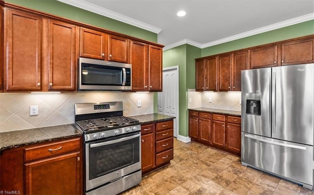 kitchen with appliances with stainless steel finishes, ornamental molding, tasteful backsplash, and dark stone countertops