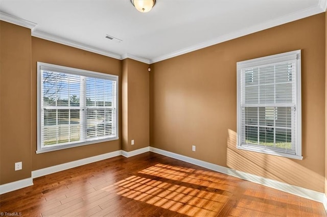 spare room featuring ornamental molding and hardwood / wood-style flooring