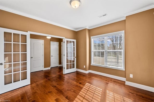 spare room featuring crown molding, french doors, and dark hardwood / wood-style flooring