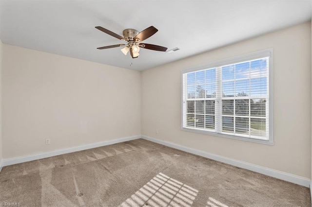 empty room featuring ceiling fan and light colored carpet