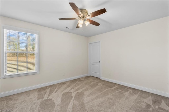 carpeted empty room featuring ceiling fan