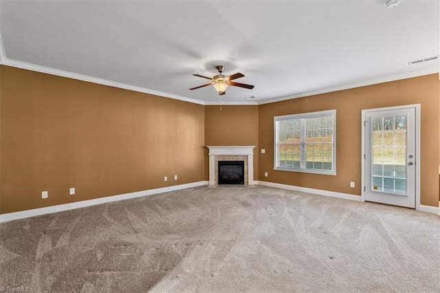 unfurnished living room featuring ornamental molding, light carpet, and ceiling fan