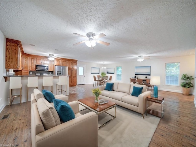 living room featuring light hardwood / wood-style floors and a textured ceiling