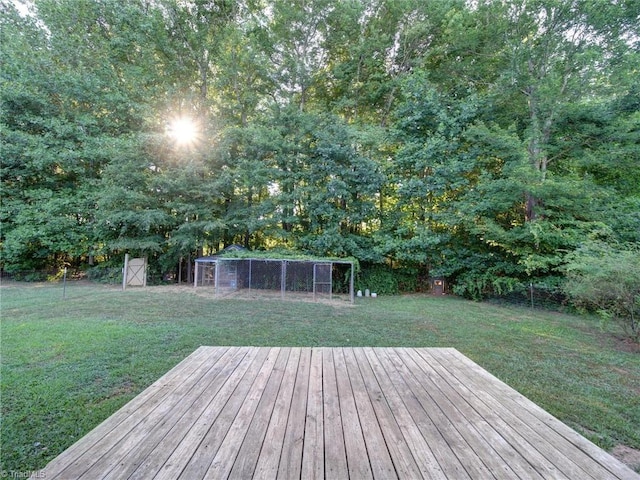 wooden deck featuring an outbuilding and a yard