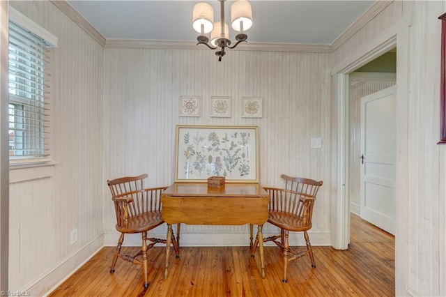 sitting room featuring ornamental molding, an inviting chandelier, and light hardwood / wood-style flooring