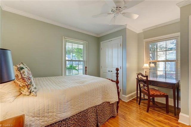 bedroom featuring crown molding, a closet, ceiling fan, and light hardwood / wood-style flooring