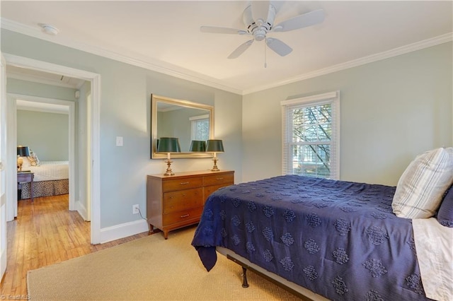 bedroom featuring ornamental molding, ceiling fan, and light hardwood / wood-style flooring