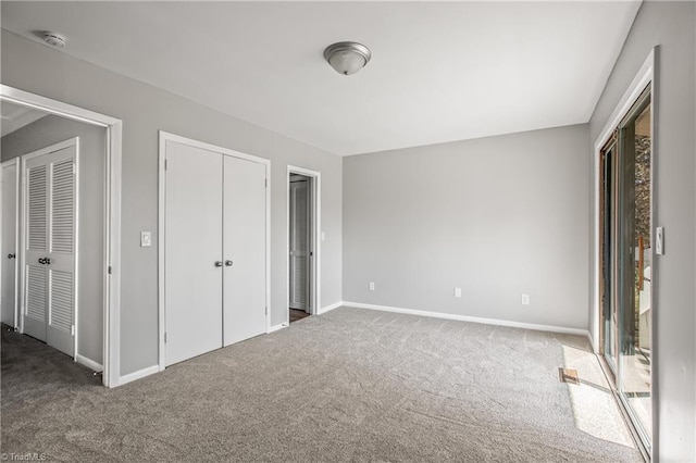 unfurnished bedroom featuring carpet floors and baseboards