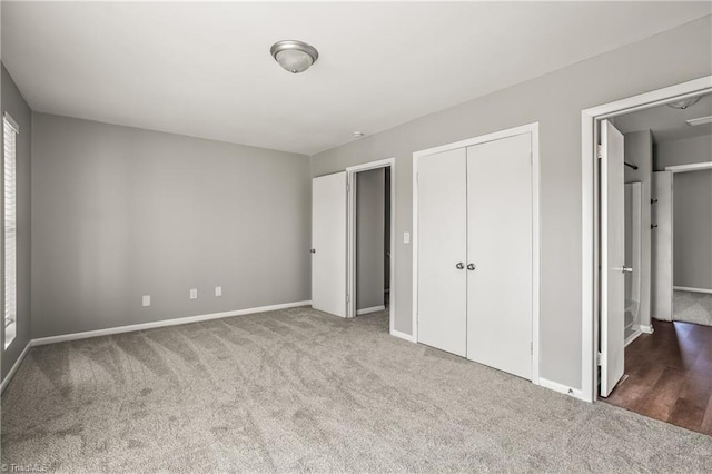 unfurnished bedroom featuring carpet floors, a closet, and baseboards