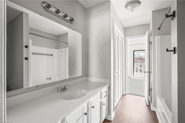 full bathroom featuring a shower, a bathtub, wood finished floors, and vanity