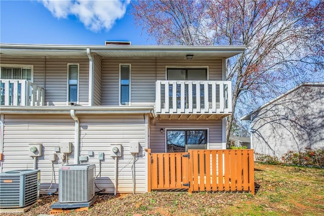 rear view of house with a balcony and central AC unit