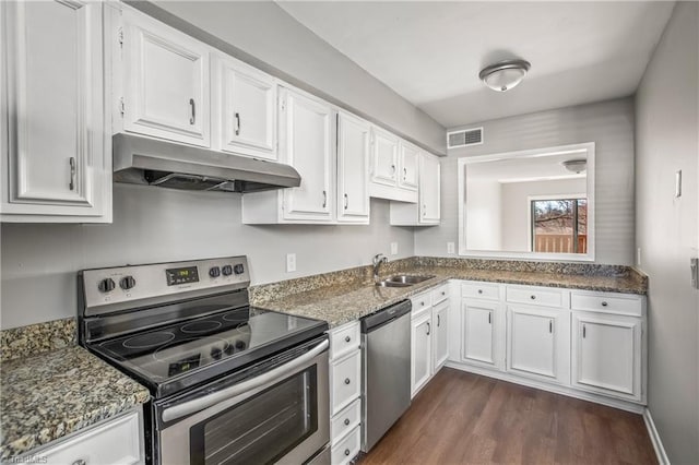 kitchen featuring white cabinetry, under cabinet range hood, visible vents, and appliances with stainless steel finishes