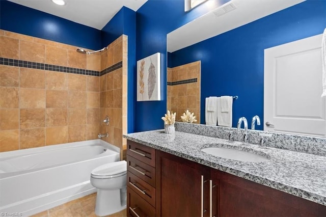 full bathroom with vanity, toilet, tile patterned flooring, and tiled shower / bath