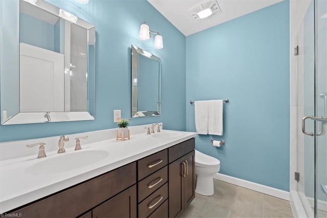 bathroom with tile patterned floors, toilet, vanity, and walk in shower