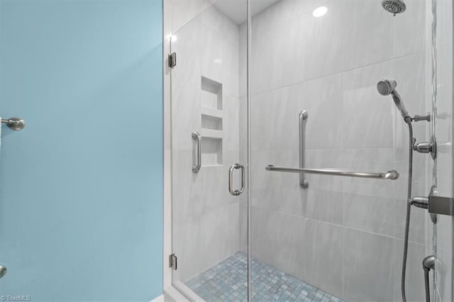 bathroom with a shower with door