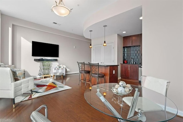 dining area with dark hardwood / wood-style floors and sink