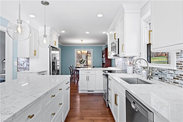 kitchen featuring dark wood-type flooring, a sink, stainless steel appliances, white cabinets, and crown molding