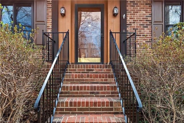 doorway to property with brick siding