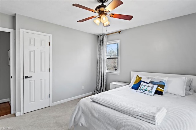 carpeted bedroom featuring a ceiling fan and baseboards